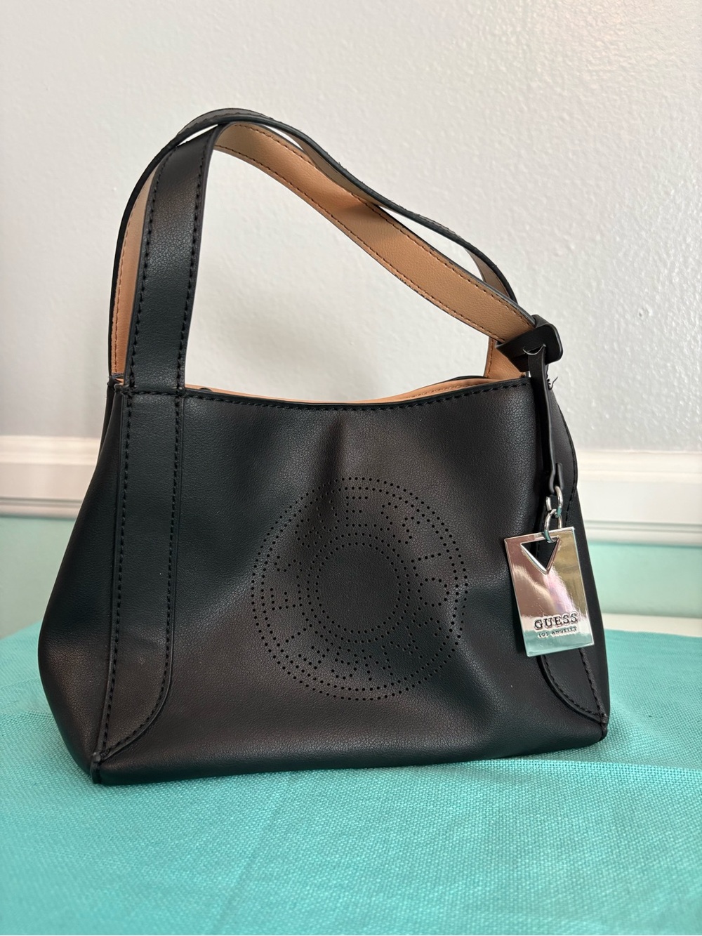 GUESS Black Shoulder Bag with Perforated Circle Accent